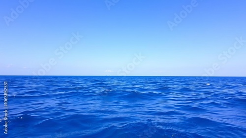 Wallpaper Mural A serene ocean background featuring crystal clear blue waters and a cloudless sky, perfect for tranquil and peaceful designs, nature, vacation Torontodigital.ca