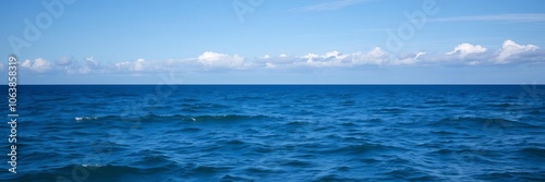 A scenic view of the vast ocean with clear blue water and a cloudy sky overhead, representing tranquility and serenity, waves, horizon