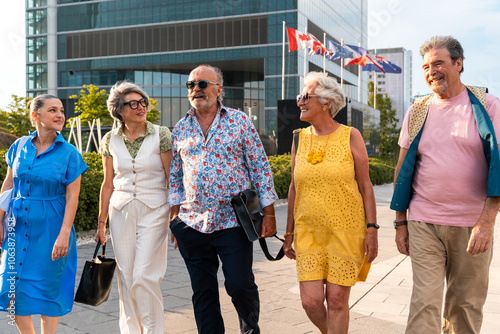 Group of senior friends meeting outdoors in the city and having fun - Cheerful old people bonding together, concepts about elderly, quality of life and aging lifestyle