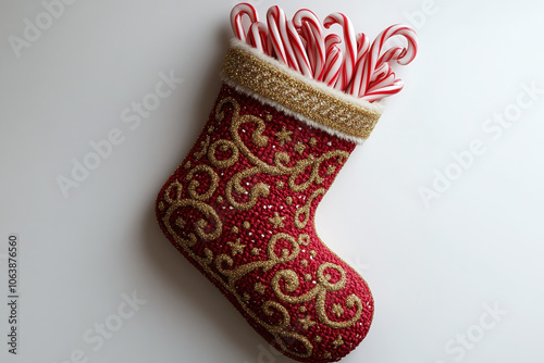 Illustration of a red and gold Christmas stocking filled with candy canes. Isolated on a white background. photo