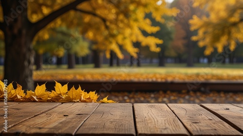 Obraz na płótnie Beautiful colorful natural autumn background for presentation. Fallen dry orange leaves on wooden boards against the backdrop of a blurry autumn park. w salonie