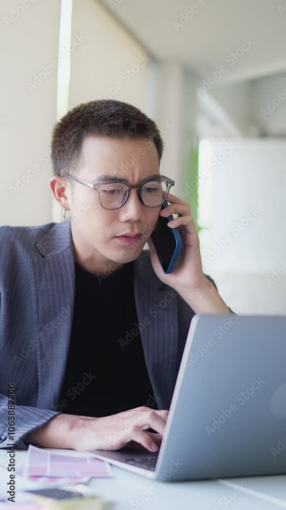 Serious young adult male working in office workplace Serious young adult male working in office workplace