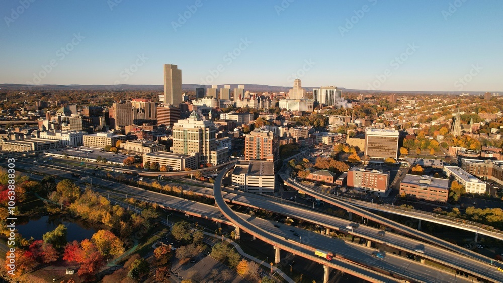 Fototapeta premium Aerial view of Albany, New York skyline during autumn with vibrant foliage and clear blue sky