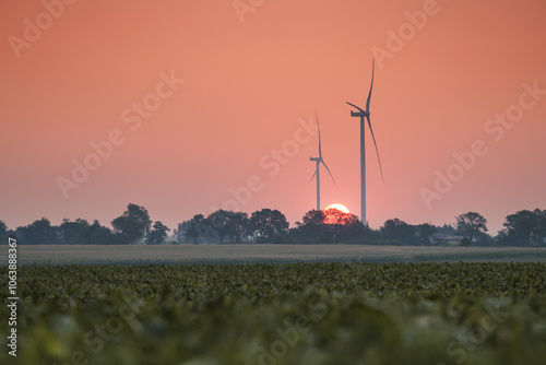 Wind turbines against the backdrop of the rising sun, green energy of planet Earth