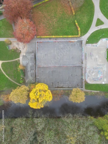 Aerial top down view of an empty skate park surrounded by trees and green grass. Taken in Hebden Bridge.  photo