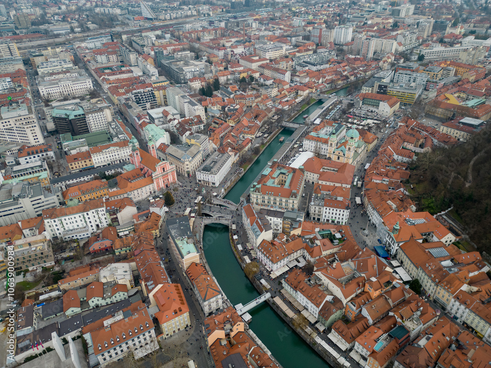 Obraz premium Ljubljana historic city center in the winter. Aerial view above Prešeren Square and Triple Bridge or Tromostovje over Ljubljanica river. Capital city of Slovenia offering many cultural events.
