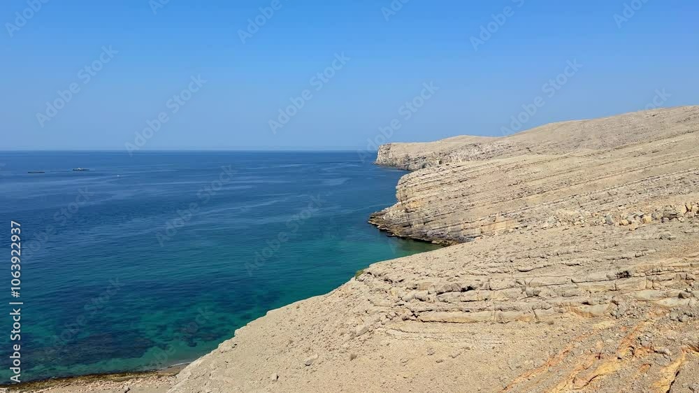 Rocky coastline and clear turquoise sea in Musandam, Oman Rocky coastline and clear turquoise sea in Musandam, Oman