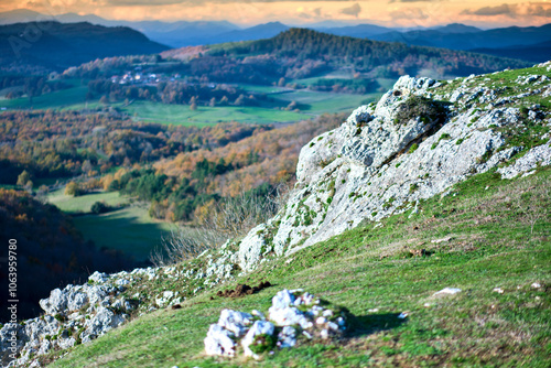 Rocky hillside with panoramic view of rolling hills and autumn forests