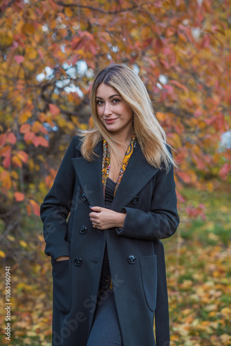 Blonde hair lady in black wool coat and golden scarf, fashionable trends for women, real photo outdoor portrait