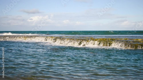 Wild waves crashing on rocky reefs at the beach in Arembepe - Bahia, Brazil photo