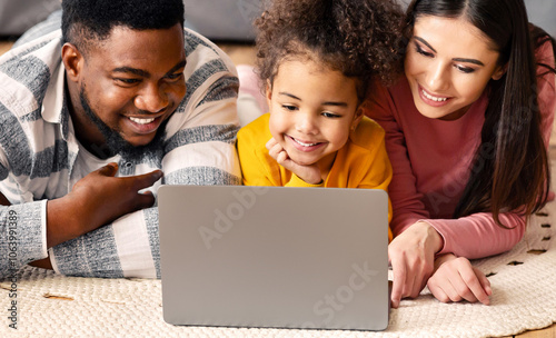 International family on the floor watching laptop and communicate with relatives online during quarantine