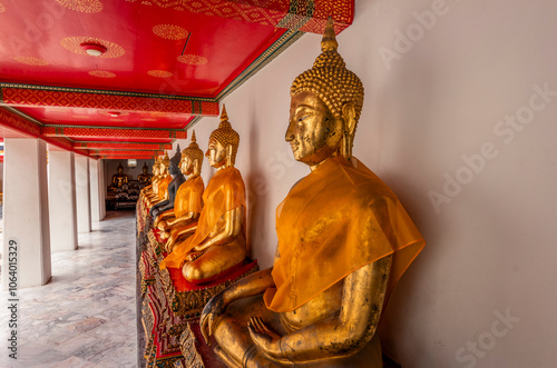 Details from statues of Buddha and monks in a temple in Bangkok photo