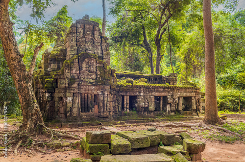 Roots, overgrown silk-cotton and strungler fig trees and ruins at the Ta Prohm temple in the Cambodian jungle photo