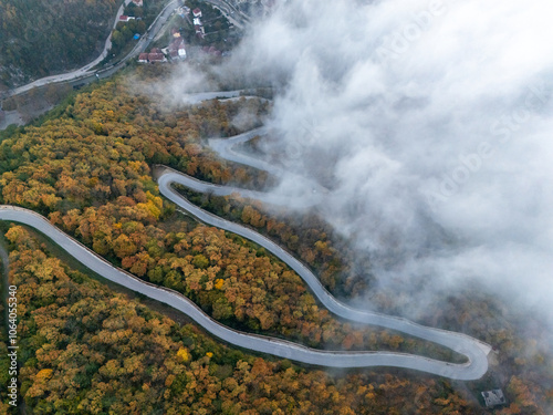 Drone Photo of a Winding Road Through Dense Forests on a High Mountain in Yenice, Karabük in Foggy Weather photo