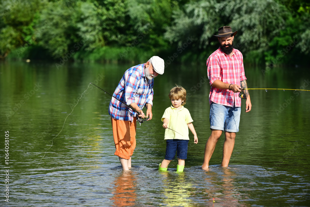 Grandson with father and grandfather fishing by lake. Summer day. Male multi generation family. Family generation and people concept. Grandson with father and grandfather fishing by lake. Summer day. Male multi generation family. Family generation and people concept.