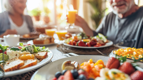 Senior Caucasian couple enjoying a colorful breakfast spread at a sunlit table, filled with laughter and conversation.