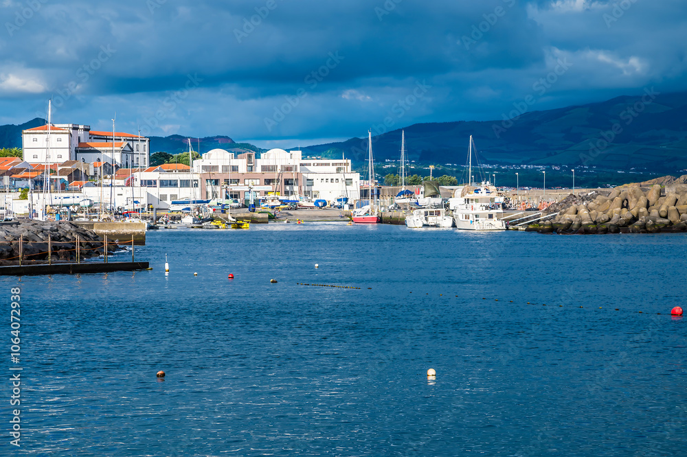 A view towards the entrance to the inner harbor in Ponta Delgada in the Azores in summertime A view towards the entrance to the inner harbor in Ponta Delgada in the Azores in summertime