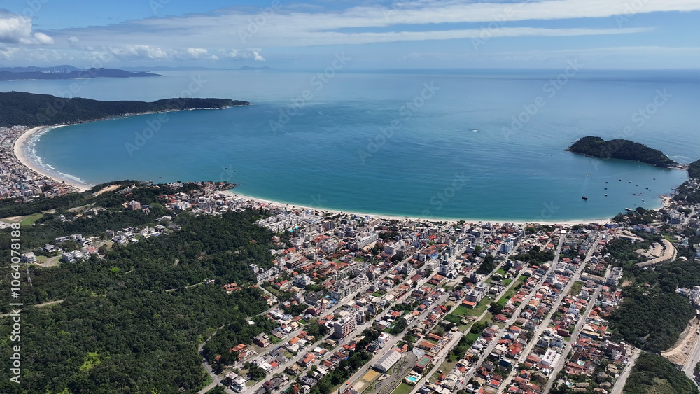 Fototapeta premium Bombinhas Skyline At Bombinhas In Santa Catarina Brazil. Beach Landscape. Nature Seascape. Travel Destination. Bombinhas Skyline At Bombinhas In Santa Catarina Brazil. Turquoise Water.