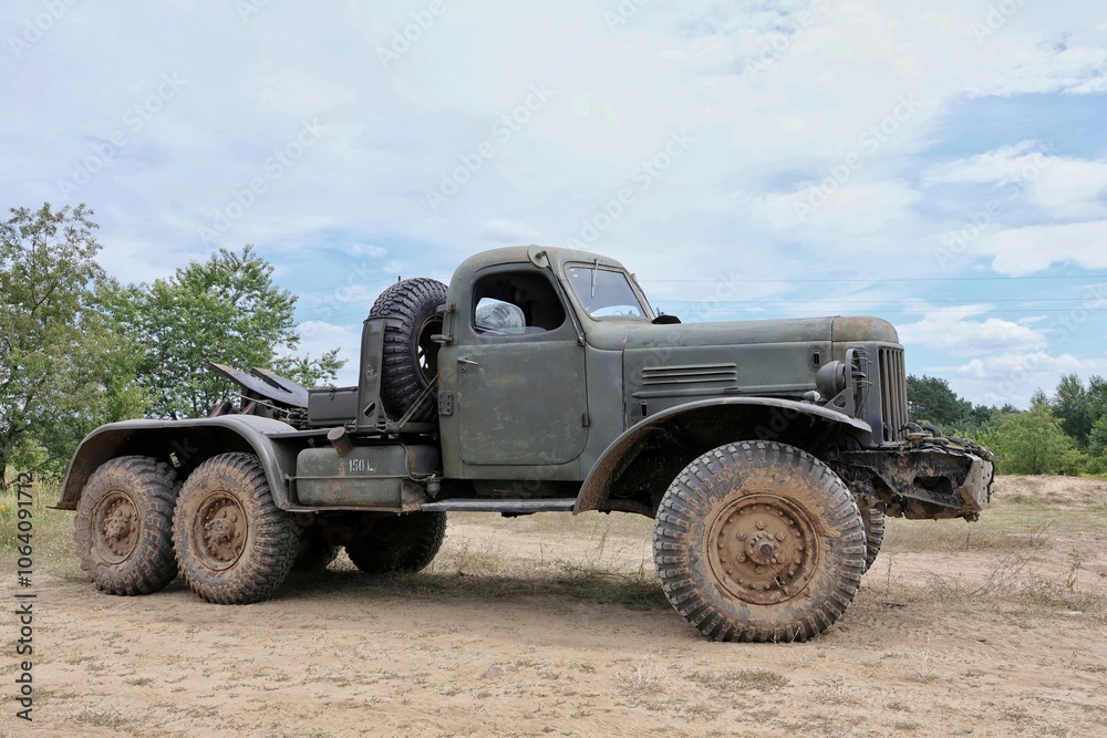 An old Soviet semi-trailer tractor standing in a field An old Soviet semi-trailer tractor standing in a field