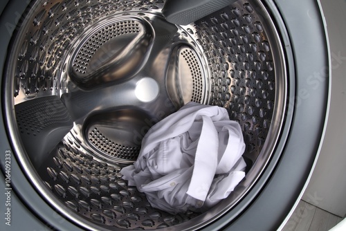 Washing machine with shirt as background, closeup