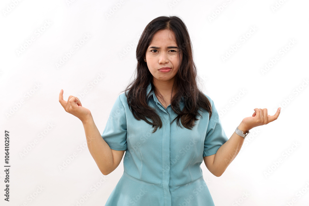 So what. Angry Asian woman raises eyebrows from annoyance keeps palms sideways shrugs shoulders with hesitation wears casual shirt isolated white background looks with bewilderment. So what. Angry Asian woman raises eyebrows from annoyance keeps palms sideways shrugs shoulders with hesitation wears casual shirt isolated white background looks with bewilderment.