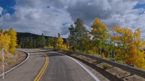 Immersive driver's point of view journey through mountains at peak fall foliage from Steamboat Springs to Yampa, Colorado.