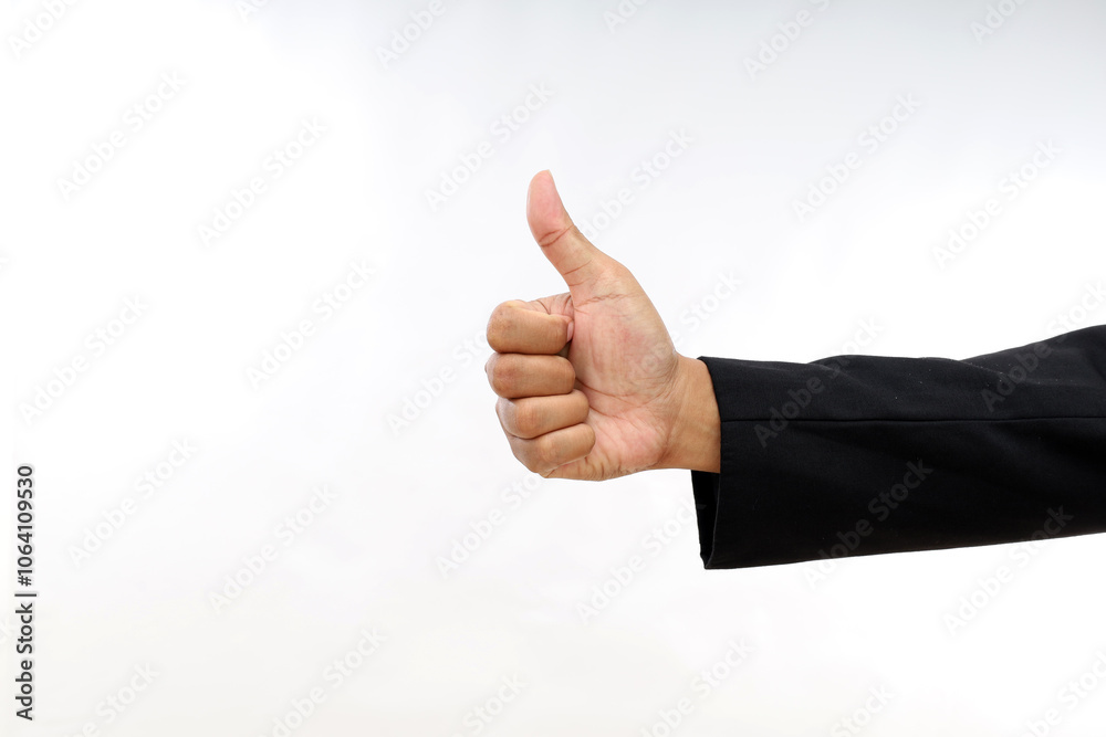 A businessman's hand making thumbs up hand gesture