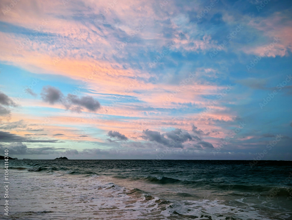 Golden hour clouds above the tranquil ocean waves at dusk on a serene beach Golden hour clouds above the tranquil ocean waves at dusk on a serene beach