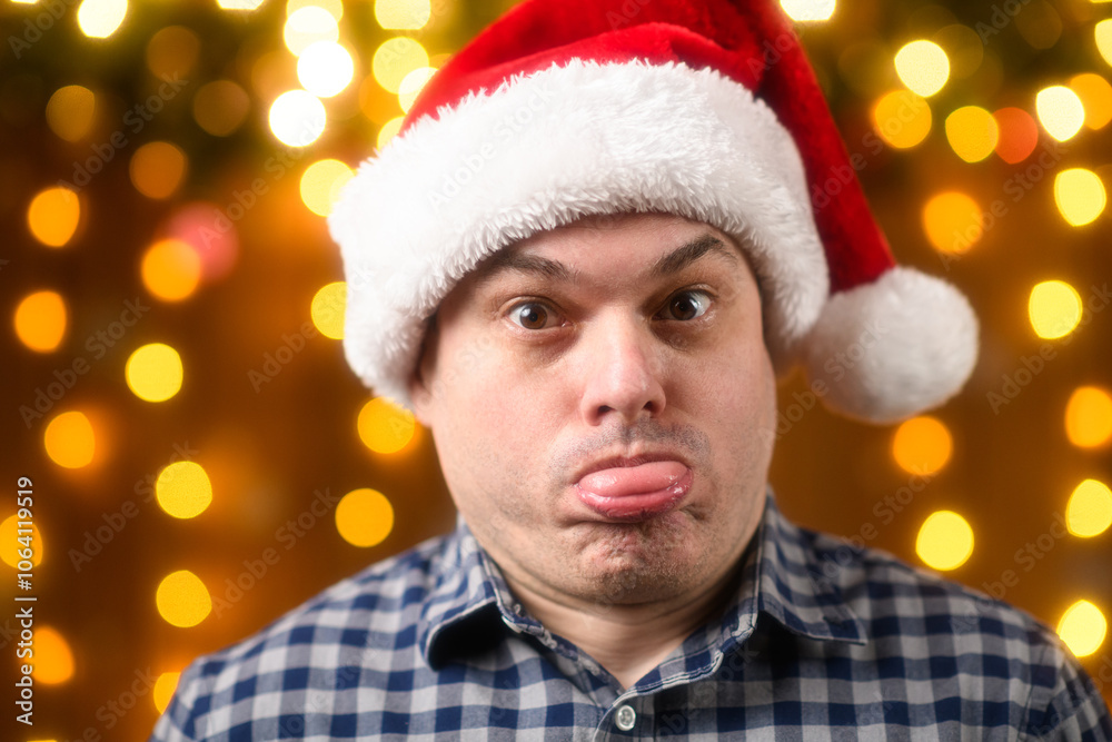 A man face, poses in New Year decorations with festive illumination and garlands, Christmas lights and decorations background, Holiday theme A man face, poses in New Year decorations with festive illumination and garlands, Christmas lights and decorations background, Holiday theme