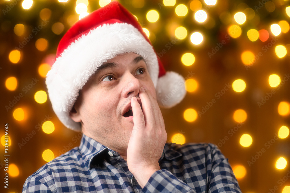 A man face, poses in New Year decorations with festive illumination and garlands, Christmas lights and decorations background, Holiday theme A man face, poses in New Year decorations with festive illumination and garlands, Christmas lights and decorations background, Holiday theme
