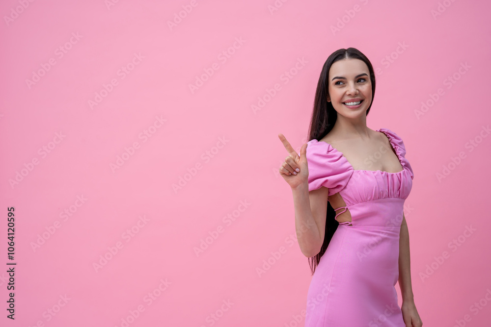 Excited young cute dark-haired young woman on a pink background Excited young cute dark-haired young woman on a pink background