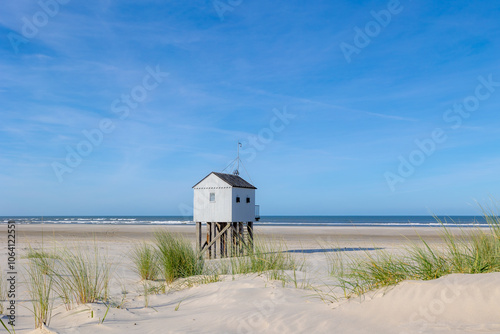 A wooden shelter on high stilts that stands on the North Sea beach (De Drenkelingenhuisje) The Dutch Wadden Sea island Terschelling, Municipality and an island in the northern, Friesland, Netherlands. photo