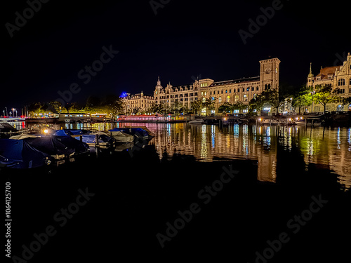 Beautiful aerial view of the city of Zurich in Switzerland at night - the Limmat River and its iconic churches, buildings rivers and Clocks. photo