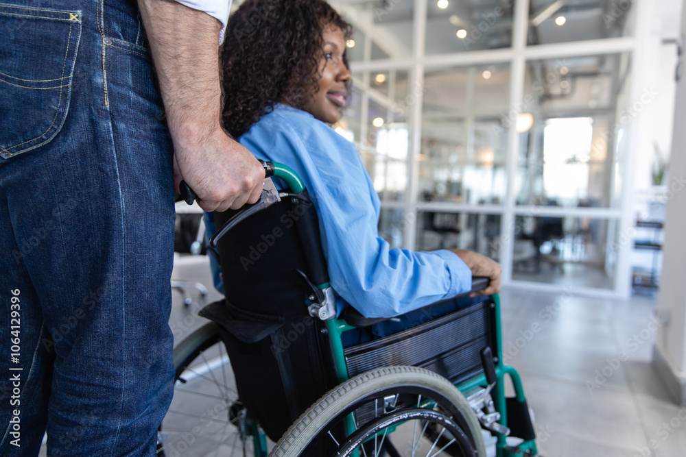 Obraz premium Woman in wheelchair managing her job despite her disability posing in modern office
