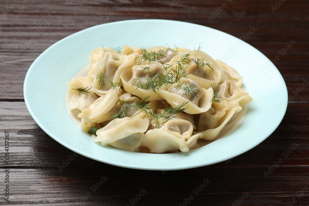 Delicious pelmeni with dill on wooden table Delicious pelmeni with dill on wooden table