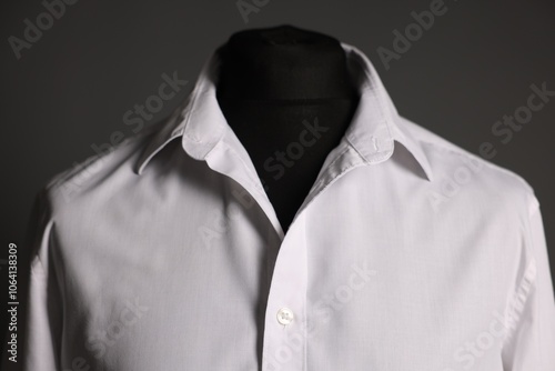 Male mannequin with white shirt on grey background, closeup