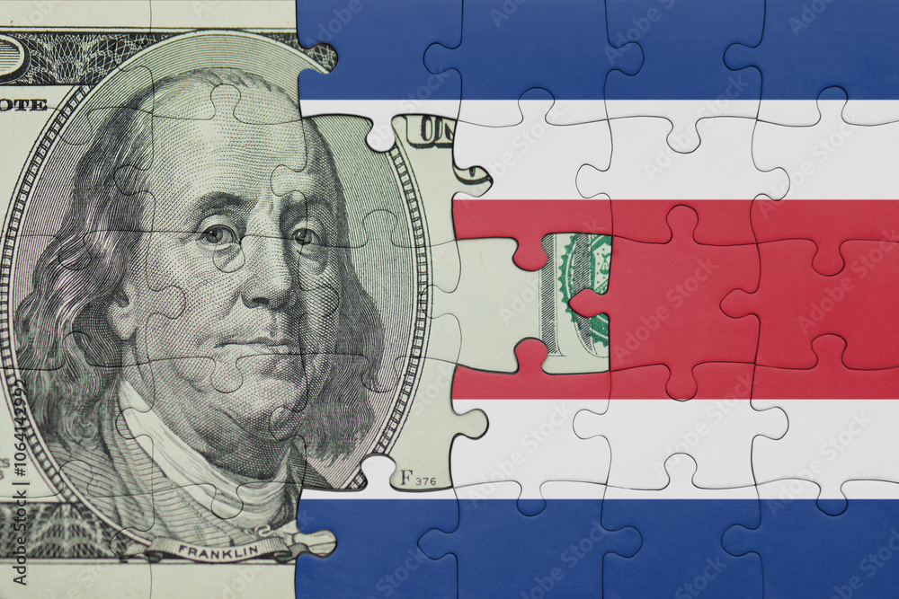 puzzle with the national flag of costa rica and the usa dollar money .finance concept puzzle with the national flag of costa rica and the usa dollar money .finance concept