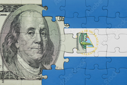 Wallpaper Mural puzzle with the national flag of nicaragua and the usa dollar money .finance concept Torontodigital.ca