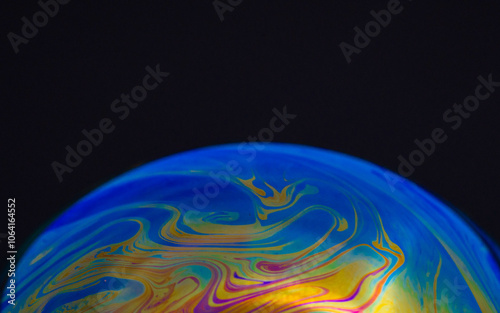 drawing of the earth on a hemisphere in a macro soap bubble on a black background, empty space for an inscription, ecology