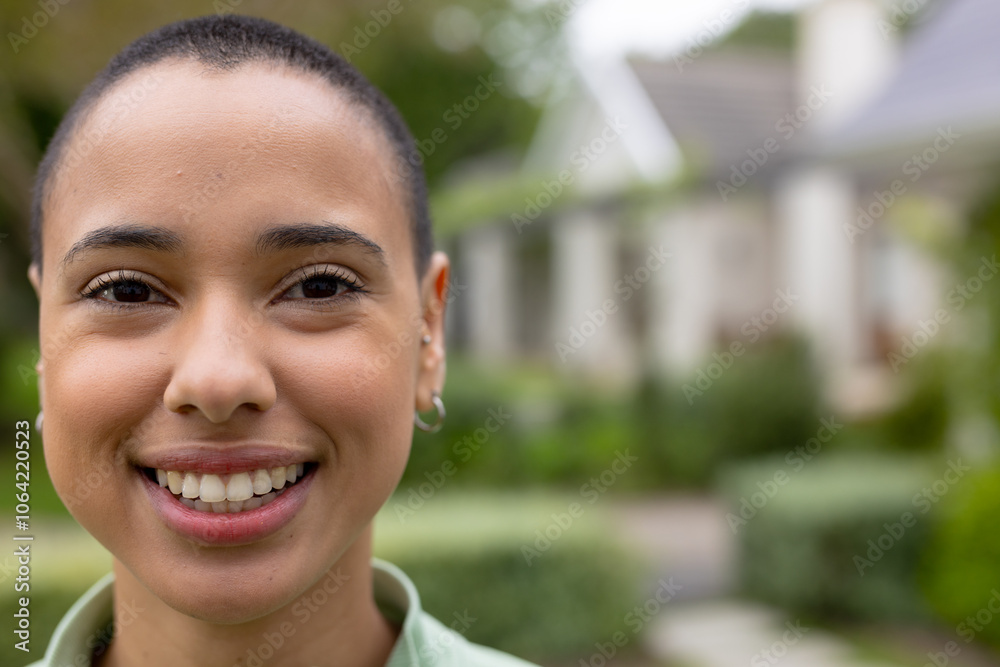 Smiling young woman enjoying time outdoors in lush garden setting, copy space Smiling young woman enjoying time outdoors in lush garden setting, copy space