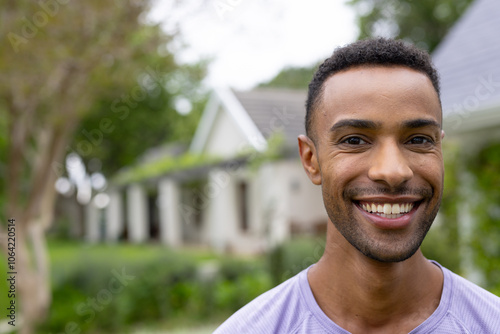 Smiling young african american outdoors in residential neighborhood, copy space