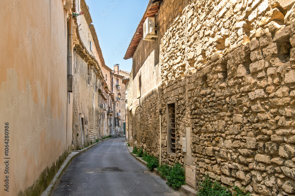 A narrow cobblestone alley with stone walls in the medieval center of Saint-Rémy-de-Provence, France, a commune in the Bouches-du-Rhône department in the Provence-Alpes-Côte d'Azur region.
A narrow cobblestone alley with stone walls in the medieval center of Saint-Rémy-de-Provence, France, a commune in the Bouches-du-Rhône department in the Provence-Alpes-Côte d'Azur region.