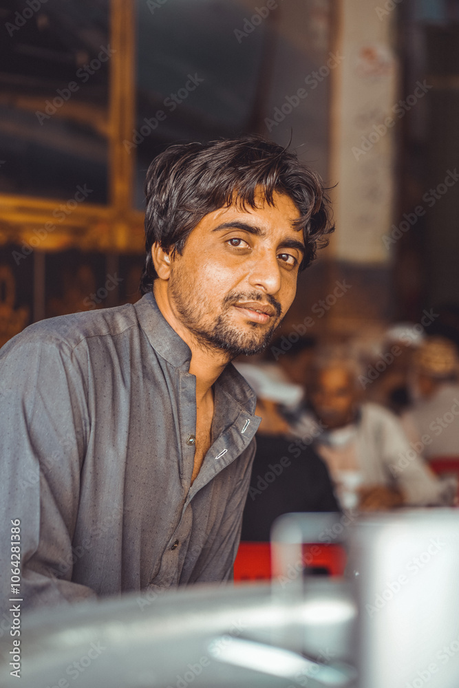 Portrait of a poor Middle aged Pakistani man, working in his shop Portrait of a poor Middle aged Pakistani man, working in his shop
