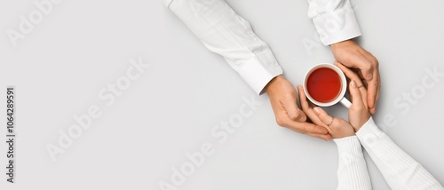 Hands of couple with cup of...