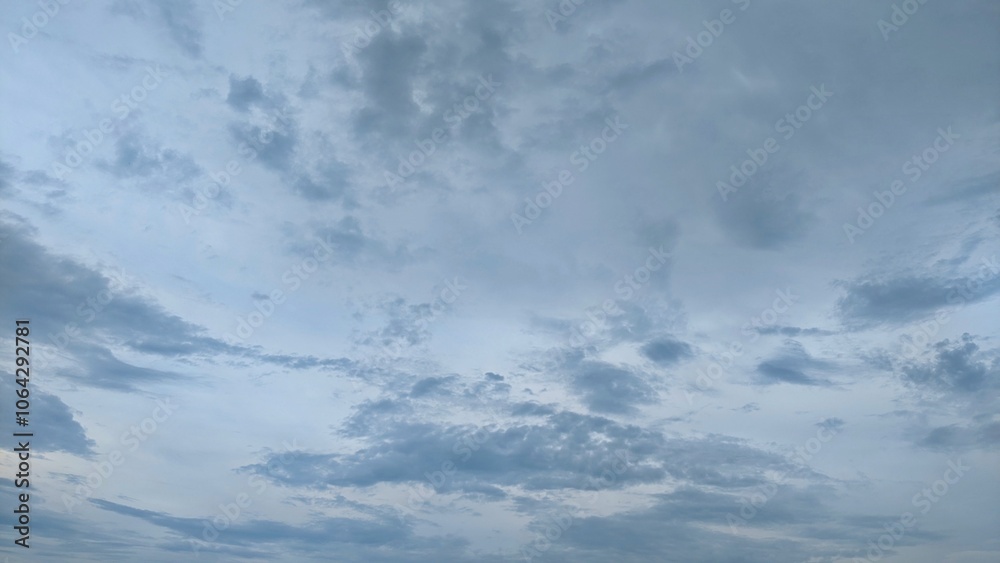 A cloudy sky with a mix of dark gray and lighter gray clouds. The clouds are thick and appear to be moving quickly. There is a distinct line separating the dark and light areas of the sky. A cloudy sky with a mix of dark gray and lighter gray clouds. The clouds are thick and appear to be moving quickly. There is a distinct line separating the dark and light areas of the sky.