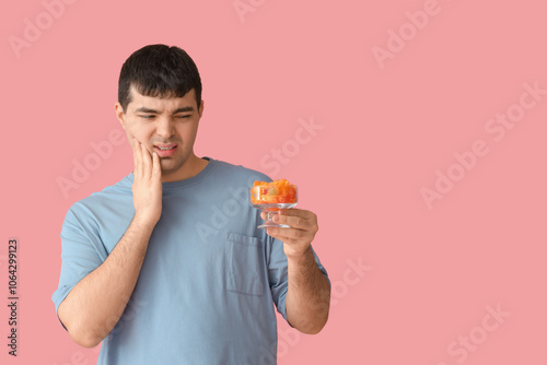 Young man with candies suff...