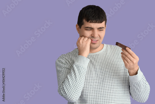 Young man with candy bar su...