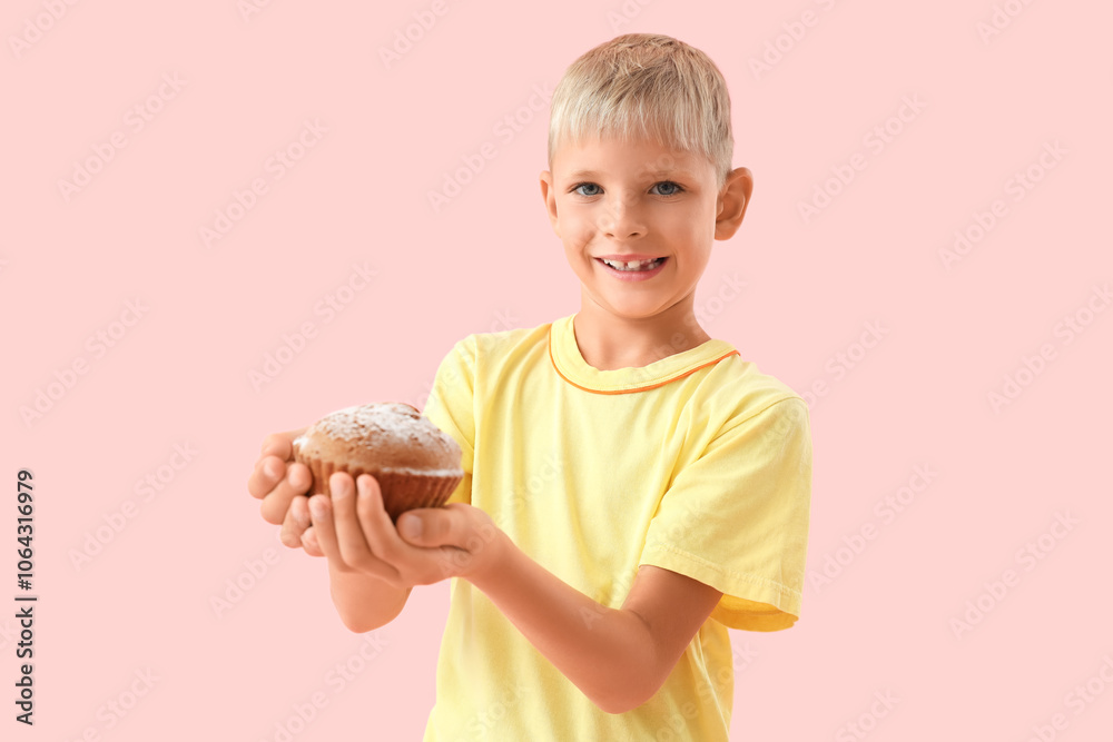 Little boy with tasty muffin on pink background Little boy with tasty muffin on pink background