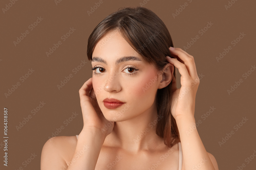 Young woman with beautiful eyebrows on brown background Young woman with beautiful eyebrows on brown background