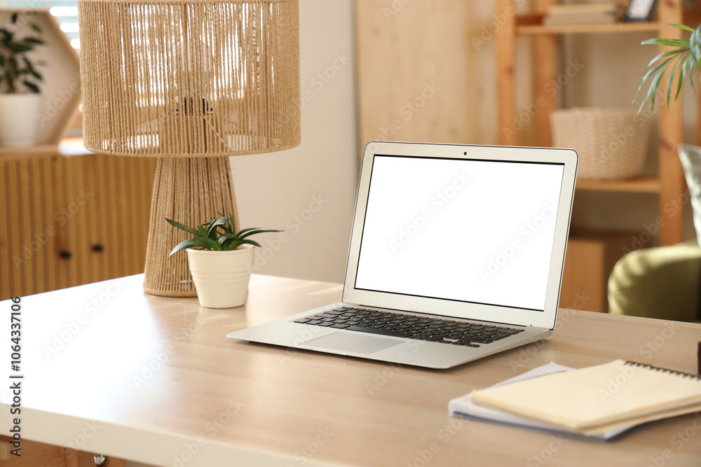 Blank laptop with plant and lamp on programmer's desk in living room, closeup Blank laptop with plant and lamp on programmer's desk in living room, closeup